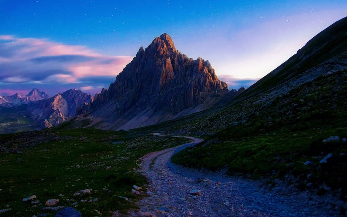 Mountain ridge with a winding road at dusk