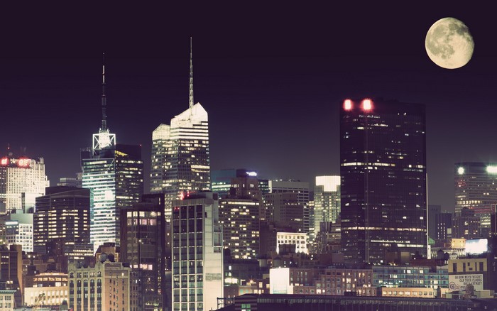 New York City skyline at night with moon