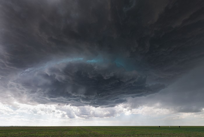 Stormy clouds over a green field