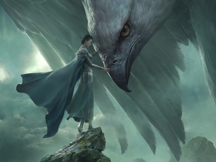 Woman touching a giant bird on a rocky outcrop