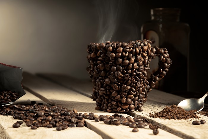 Coffee cup made of coffee beans with steam