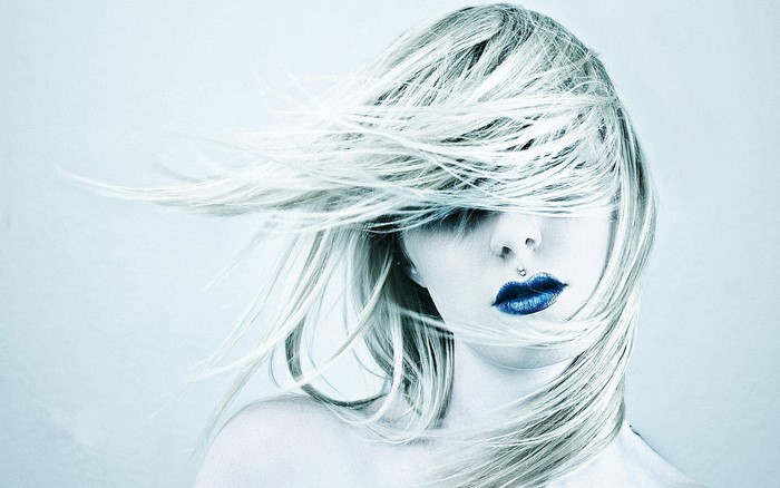 Woman with windblown hair and blue lipstick