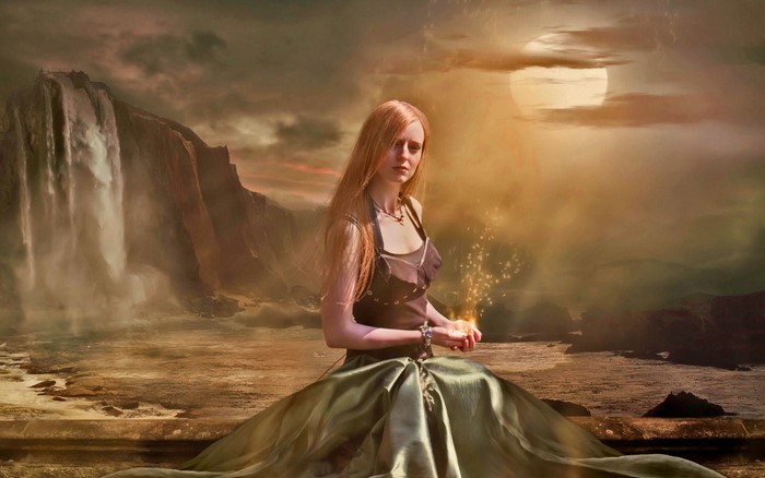 Woman with magic sparks near waterfall
