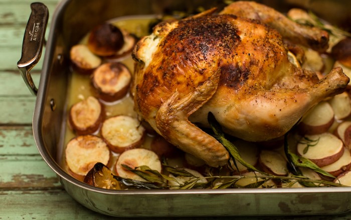 Roasted chicken with potatoes in a roasting pan