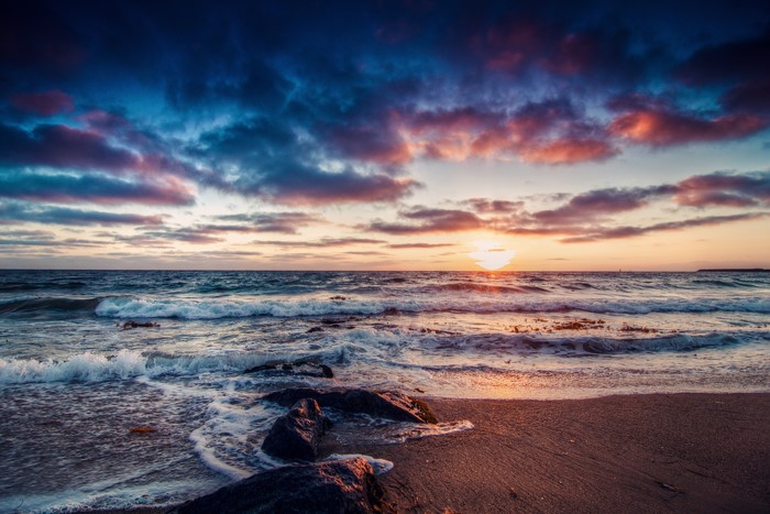 Sunset over the ocean with dramatic clouds