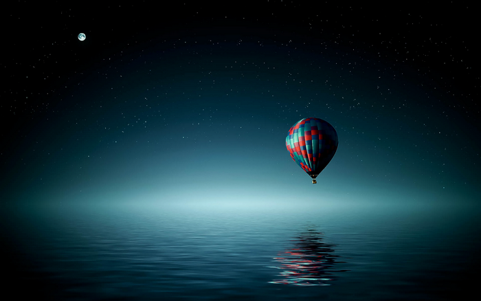 Hot air balloon over the ocean at night with moon and stars