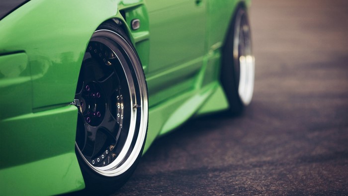 Green sports car with custom wheels