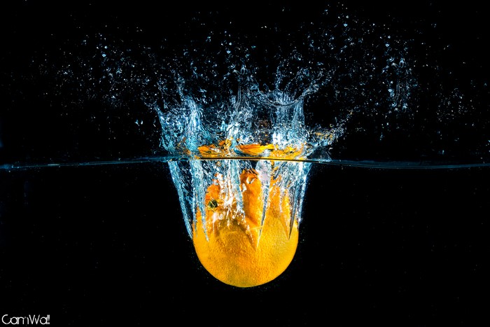 Orange splashing into water