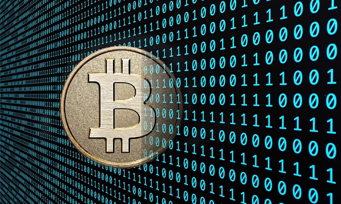 Bitcoin coin on a background of binary code