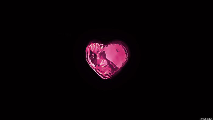 Pink crystal heart with glow on black background