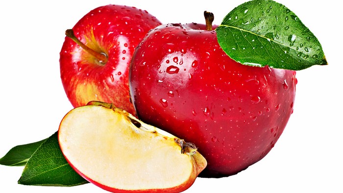 Red apples with water droplets and a slice
