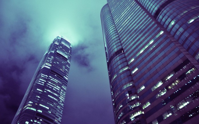 Two skyscrapers against a cloudy sky
