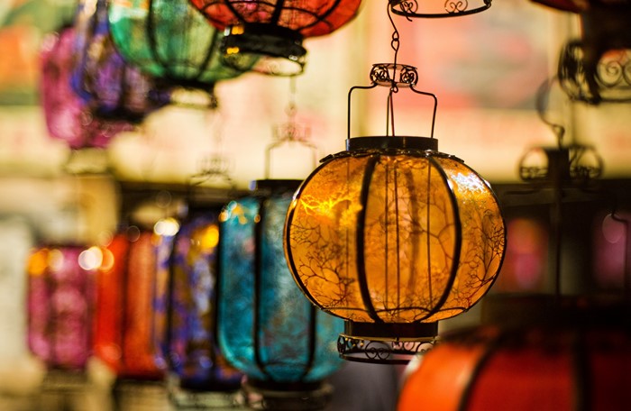 Many colorful lanterns hanging in a market