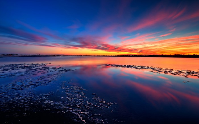 Sunset over a calm lake with colorful clouds