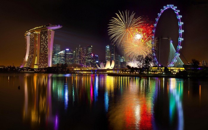Singapore Skyline with Fireworks and Ferris Wheel at Night