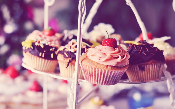 Cupcakes with frosting and sprinkles on a tiered stand