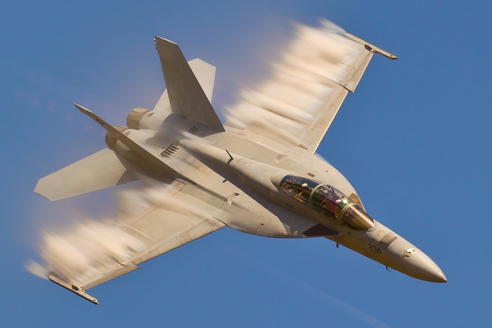 F/A-18 Super Hornet in flight with vapor trails