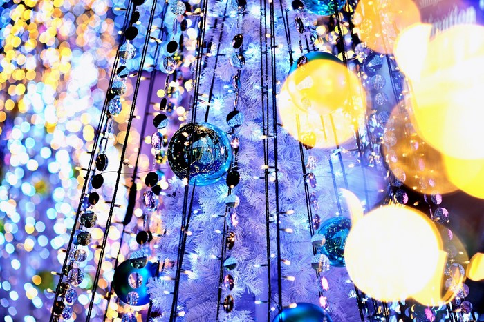 Christmas tree with blue and yellow ornaments and lights