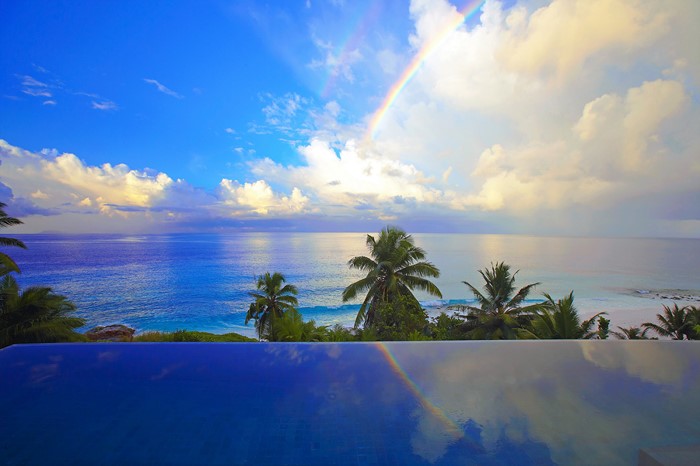 Tropical Ocean with Rainbow and Palm Trees