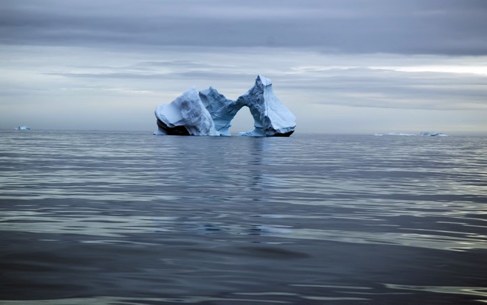 Iceberg with arch in the ocean