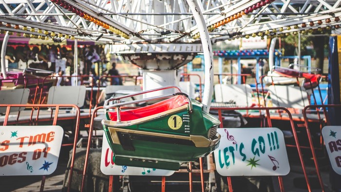 Amusement park ride with colorful seats and signs