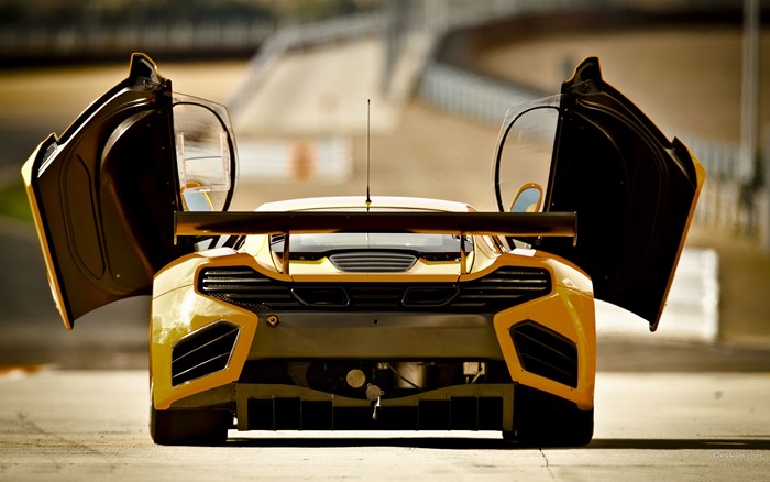 Yellow McLaren race car with doors open