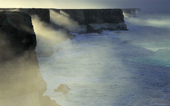 Misty cliffs and ocean waves