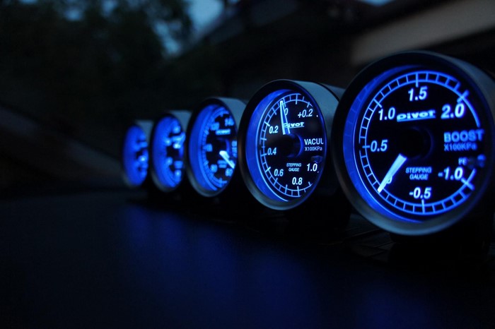 Car dashboard gauges with blue illumination