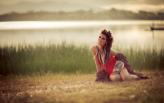 Woman with dreadlocks by a lake
