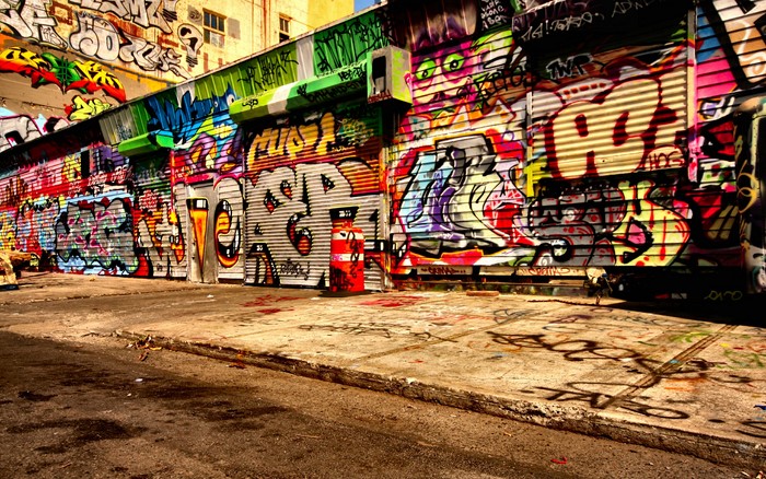 Graffiti-covered urban storefront and alleyway