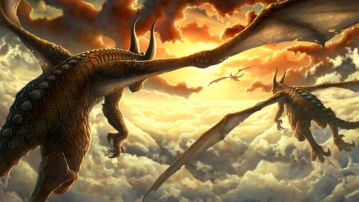 Dragons flying over clouds at sunset