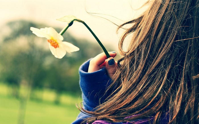 Woman holding a white flower