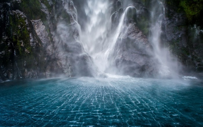 Waterfall cascading into a blue pool
