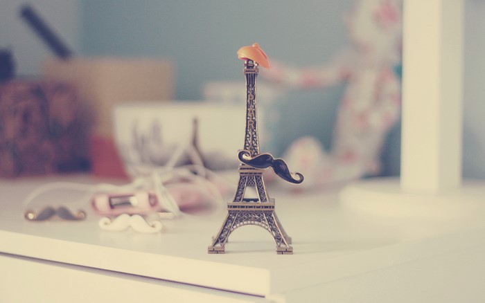 Miniature Eiffel Tower with mustache and hat