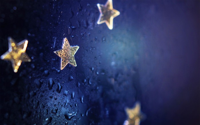 Sparkling stars on a wet dark blue surface