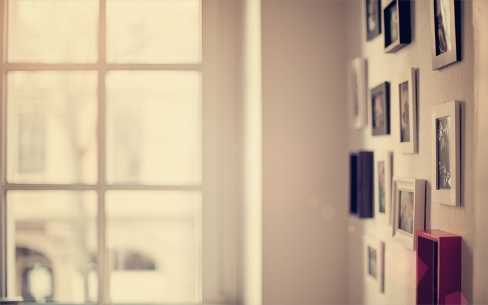 Wall with framed pictures and a window