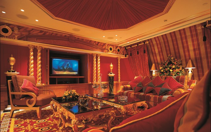 Luxurious red and gold living room with television