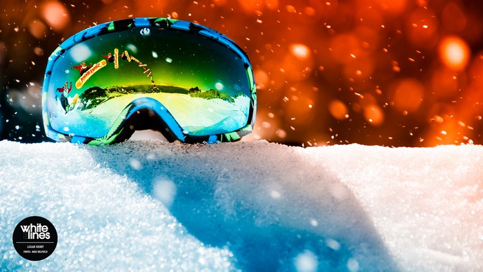 Snowboarding goggles reflecting a jump