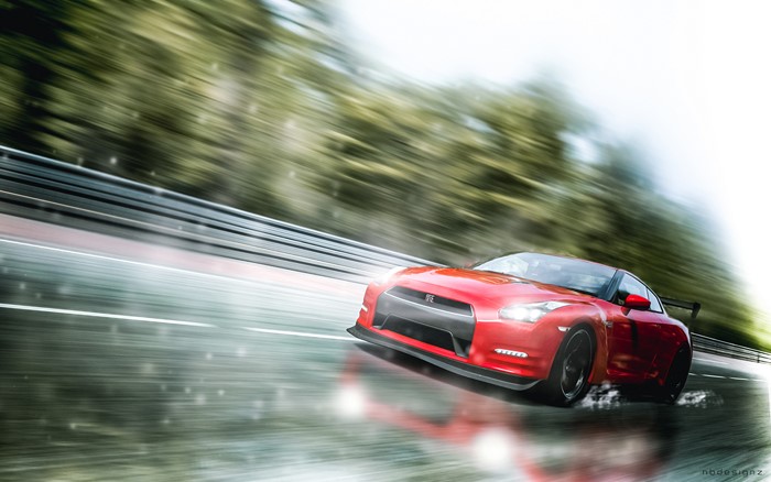 Red Nissan GT-R driving on a wet track