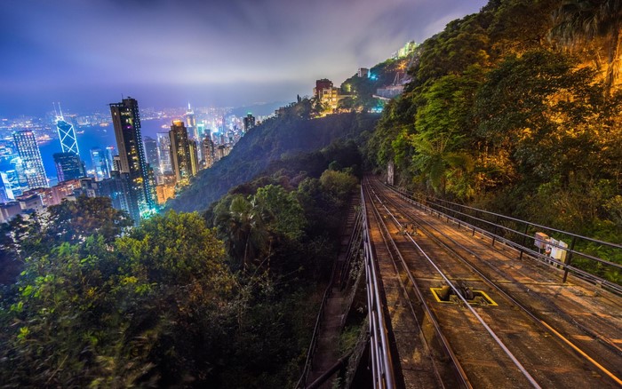 Hong Kong cityscape and tram tracks on a hill at night