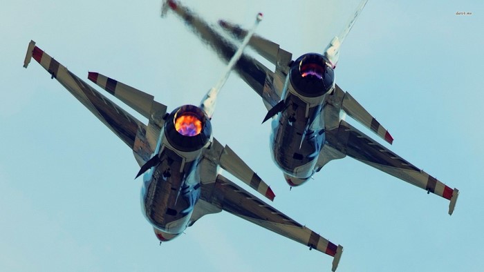Two fighter jets flying in formation