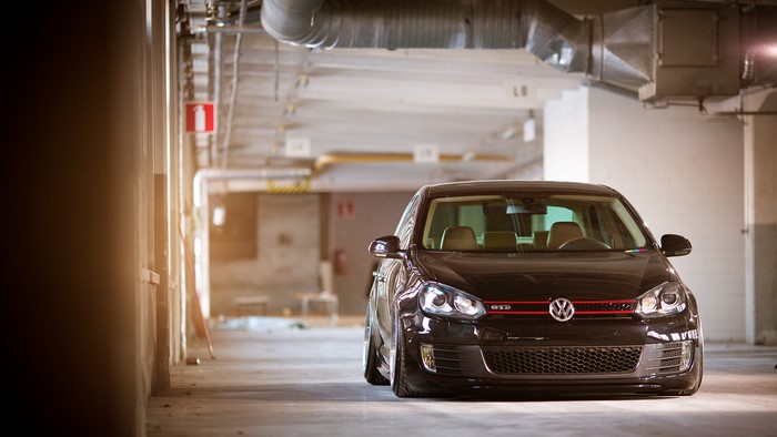 Black Volkswagen Golf GTI parked in a garage
