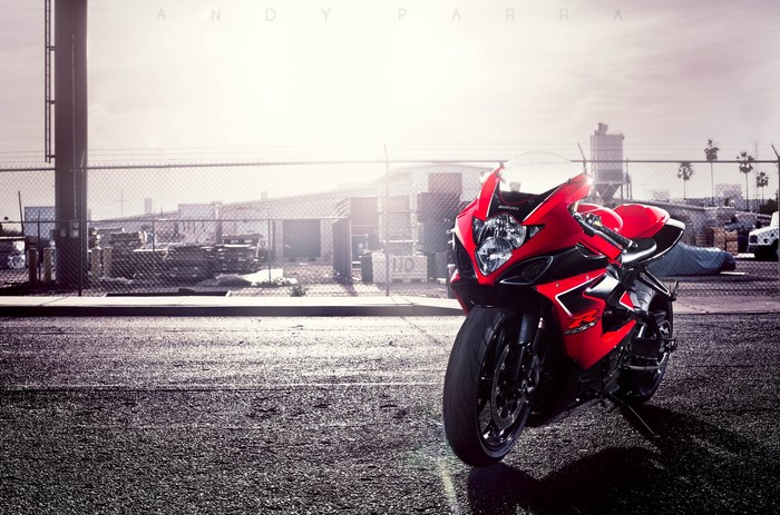 Red Suzuki motorcycle parked on asphalt