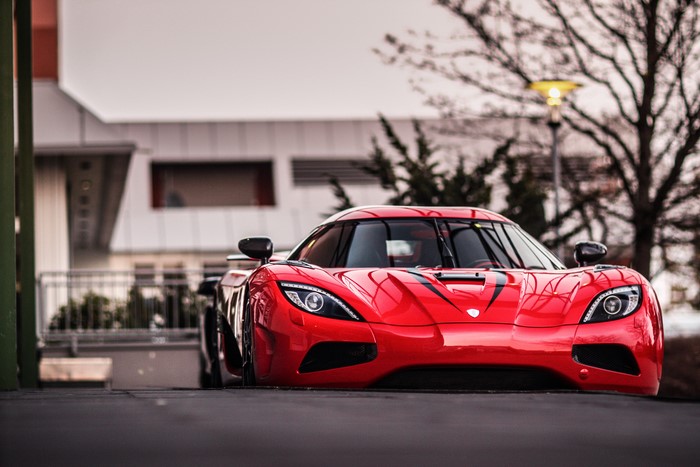 Red Koenigsegg Agera RS parked outside building