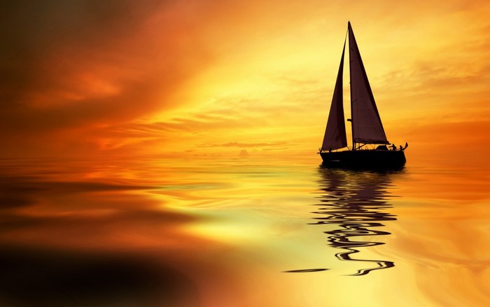 Sailboat on the ocean at sunset