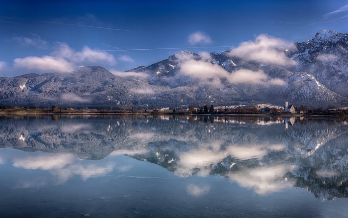Snow-covered mountains reflected in a calm lake