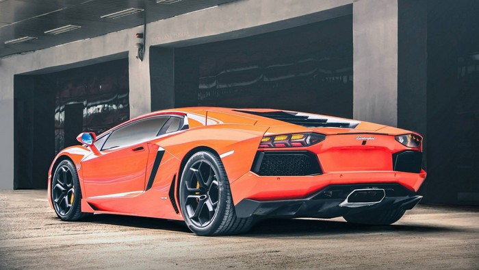 Orange Lamborghini Aventador parked in a garage