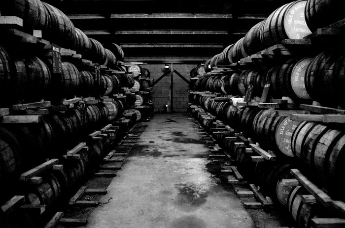 Whisky barrels stacked in a warehouse