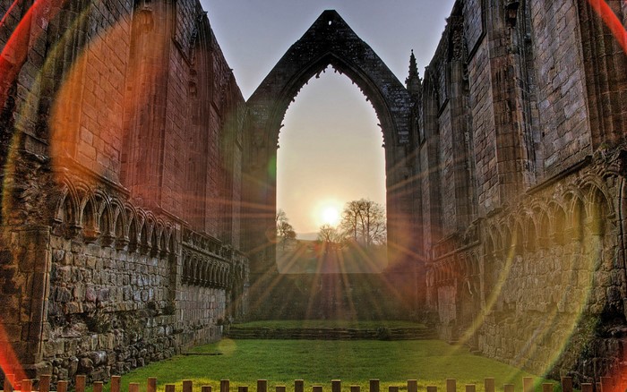 Ruins of an abbey with sunset flare