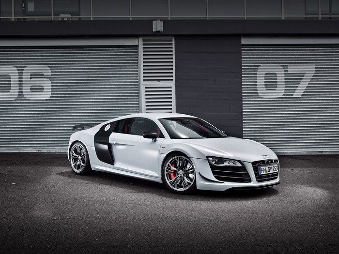White Audi R8 parked in front of garage doors